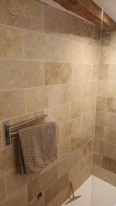 a tiled shower with a towel rack in a bathroom at Le cabanon in Flayosc