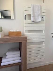 a bathroom with white towels on a wall at Les clés d'à côté - maison d'hôtes de charme près de Rouen in Sotteville-lès-Rouen +87 photos