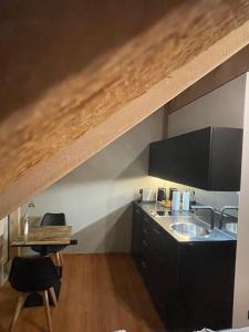 a kitchen with a sink and a wooden ceiling at Modernes und schönes Apartment VS in Villingen-Schwenningen +2 photos