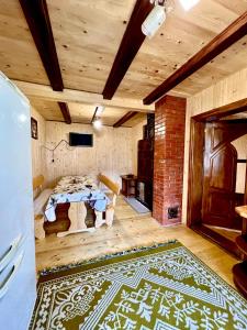 a room with a table and a brick wall at Котедж Amber in Mykulychyn