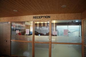 a hospital front door with a sign on it at Hotel Sai Capital in Vijayawāda