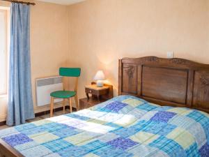 a bedroom with a bed and a chair and a window at Maison accueillante à La Chapelle-aux-Choux avec jardin spacieux 70 m² in La Chapelle-aux-Choux +4 photos