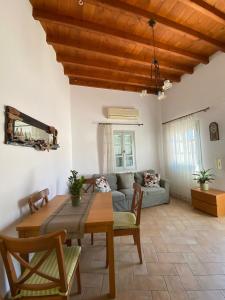 a living room with a table and a couch at EnjoyPatmos in Skala