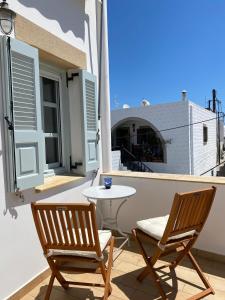 two chairs and a table on a balcony at EnjoyPatmos in Skala