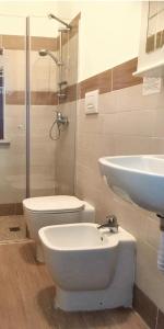 a bathroom with a toilet and a sink and a shower at Charming Studio in Vieste, 25 m², Shared Pool in Vieste +13 photos
