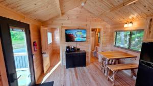 a wooden cabin with a table and a tv in it at Abbot Trailside Lodging in Abbot Village
