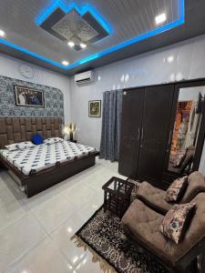 a bedroom with a bed and a couch in it at Homestay, hotel at Pathankot in Pathānkot