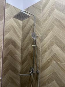 a shower with a shower head and a wooden floor at Алаша in Qotanqaraghay