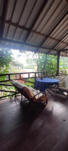 a room with a table and a hammock and a table and a tableablish at Pousada Morada do Tombo in Guarujá