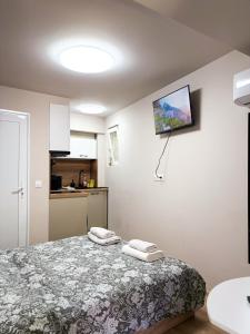a bedroom with a bed with two towels on it at Little Studio Prespa Best Location in Varna City
