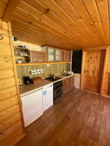 a large kitchen with wooden floors and wooden ceilings at 650m n.p.m. in Zawoja