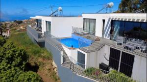 a white house with a swimming pool at CASA PANORAMA SOL- NEW VILLA WITH HEATED SALTWATER POOL and FANTASTIC SEA VIEW in Ponta do Sol