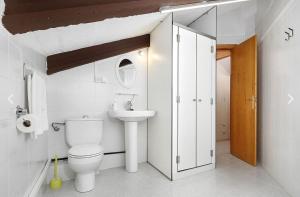 a bathroom with a toilet and a sink at Sierra de Arbe in Naval