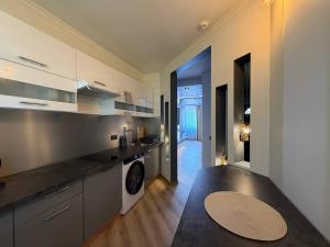 a large kitchen with a black counter top at ADAM Apartments Krāslava in Krāslava +3 photos