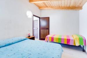 a bedroom with two beds and a wooden ceiling at Charming apartment in Pisciotta, 37 m² with terrace in Pisciotta