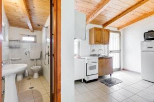 a kitchen with a sink and a toilet in a room at Charming apartment in Pisciotta, 37 m² with terrace in Pisciotta