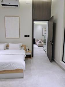 a bedroom with a bed and a door leading into a room at شاليهات ترف in Abha