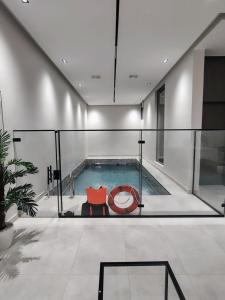a swimming pool with a red couch in a house at شاليهات ترف in Abha
