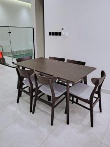 a wooden table and chairs in a room at شاليهات ترف in Abha