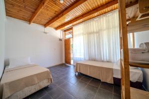 a bedroom with two beds and a window at Olympos Donkisot Pansiyon in Antalya