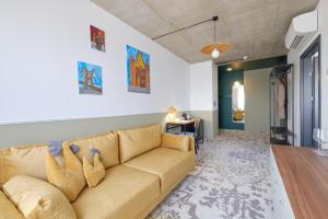 a living room with a couch and a table at Arche Hotel Wrocław Airport in Wrocław