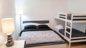 a bedroom with two bunk beds and a lamp at Villa enchanteresse à Saint-Benoît avec piscine privée in Saint-Benoît