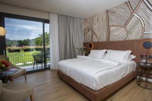 a bedroom with a large bed and a balcony at Continental Golf Resort in Verbania +79 photos
