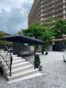 a set of stairs with a black umbrella on top at Family Hotel Keti in Kobuleti