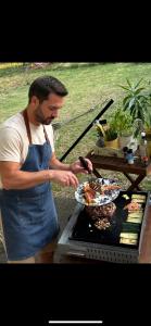 a man is preparing food on a grill at Villa la Roma in Aix-en-Provence +16 photos