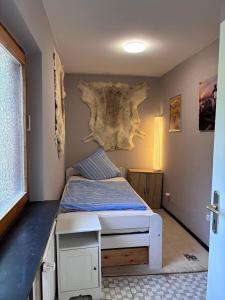 a bedroom with a bed with a tree on the wall at Tischlerei in Barum