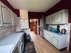 a kitchen with white cabinets and a counter top at Tischlerei in Barum