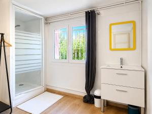 a white bathroom with a sink and a shower at " Le Grand Biarritz " Jardin - Parking - WIFI in Toulouse +33 photos