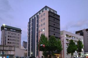 a tall building in the middle of a city at HOTEL SUI HAMAMATSU by ABEST in Hamamatsu