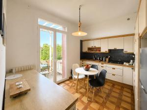 a kitchen with a table and chairs and a window at " Le Grand Biarritz " Jardin - Parking - WIFI in Toulouse