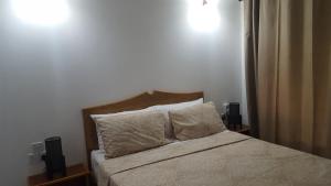 a bedroom with a bed with two speakers at Comfortable apartment in Baie Sainte Anne 56 m² with sea view in Baie Sainte Anne