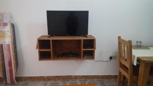 a flat screen tv sitting on top of a wall at Comfortable apartment in Baie Sainte Anne 56 m² with sea view in Baie Sainte Anne +22 photos
