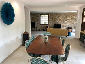 a dining room with a wooden table and chairs at Villa avec piscine à Saze in Saze