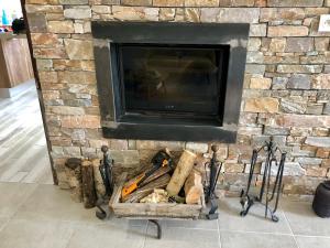 a stone fireplace with a bunch of tools in it at Villa avec piscine à Saze in Saze +14 photos
