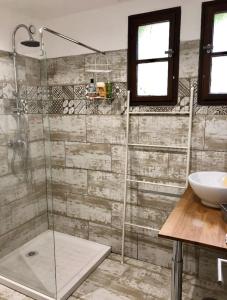 a bathroom with a shower and a sink at Villa avec piscine à Saze in Saze