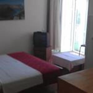 a room with two beds and a television in it at Modern Studio with Sea View - Ulcinj - 25 m² - Balcony in Ulcinj