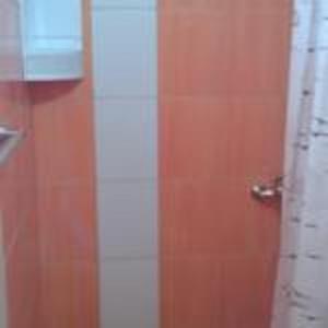 a bathroom with a wooden door and a shower at Modern Studio with Sea View - Ulcinj - 25 m² - Balcony in Ulcinj +15 photos