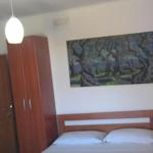 a bedroom with a bed and a picture on the wall at Modern Studio with Sea View - Ulcinj - 25 m² - Balcony in Ulcinj