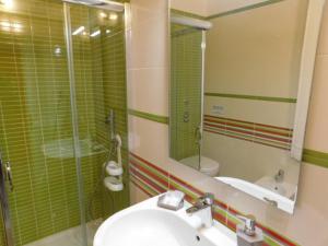 a bathroom with a sink and a shower with a mirror at Contemporary Apartment in Trapani, 50 m² with Balcony in Trapani