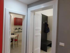 a hallway with a door leading to a kitchen at Contemporary Apartment in Trapani, 50 m² with Balcony in Trapani +20 photos