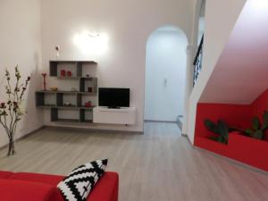 a living room with a red couch and a tv at Contemporary Apartment in Trapani, 50 m² with Balcony in Trapani