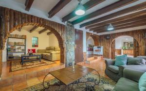 a living room with a couch and a table at Spacious House in Can Trabal in Can Trabal