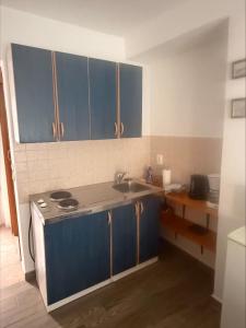 a kitchen with blue cabinets and a sink at Adrasteja 3 - apartment Dramalj in Dramalj