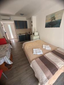 a bedroom with a large bed with towels on it at Adrasteja 3 - apartment Dramalj in Dramalj