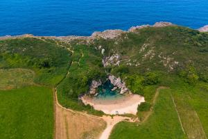 an aerial view of a mountain with a body of water at Kampaoh Playa Troenzo in Celorio