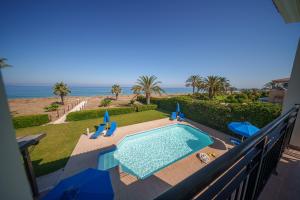 a swimming pool with a view of the ocean at Ocean Breeze Club-Villa Mare in Kato Yialia